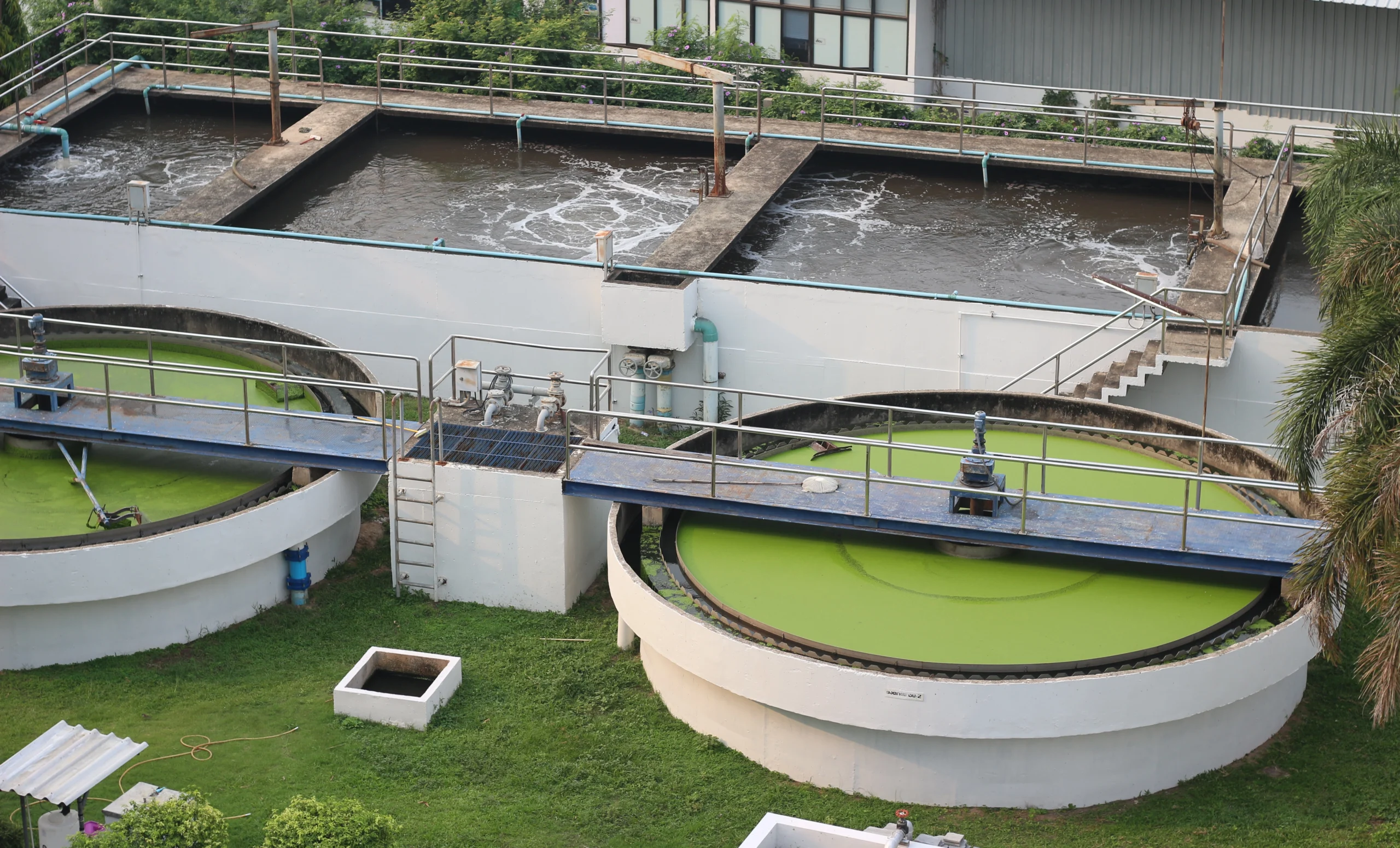 Sustainable Sewage Solutions for Indian Households - Crystal Bio Septic Tank Modern sewage treatment plant with circular clarifier tanks and aeration tanks used for wastewater purification, surrounded by greenery Crystal Bio Septic Tank